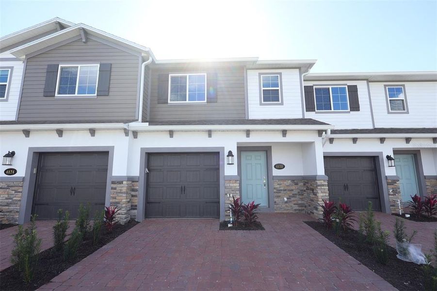 Front exterior of a new home in Tyson Ranch, Orlando, FL, highlighting curb appeal (Image 2). Front exterior of a new home in Tyson Ranch, Orlando, FL, highlighting curb appeal (Image 2).