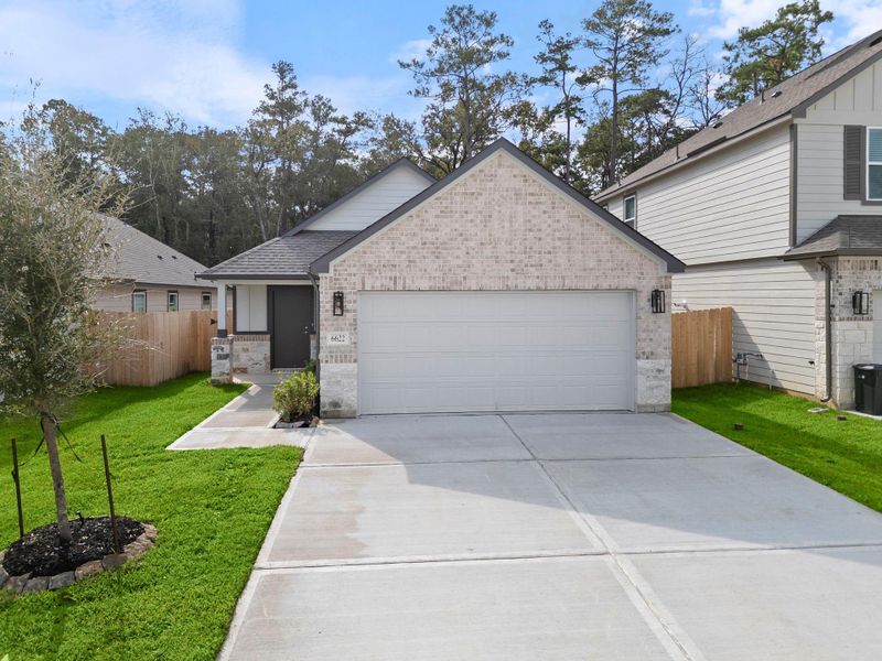 Front exterior of a new home in Cypresswood Landing, Humble, TX, highlighting curb appeal (Image 1).