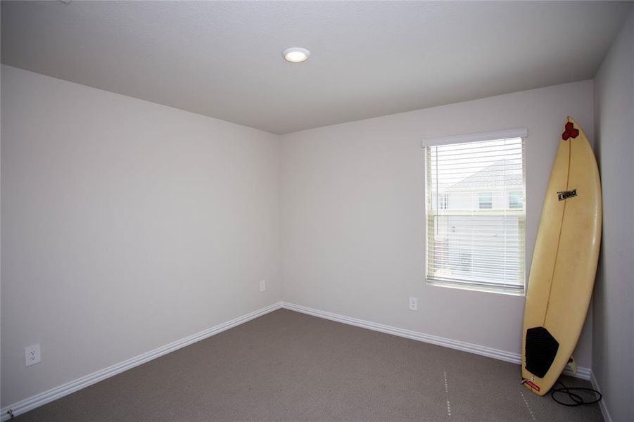Unfurnished room with carpet and baseboards