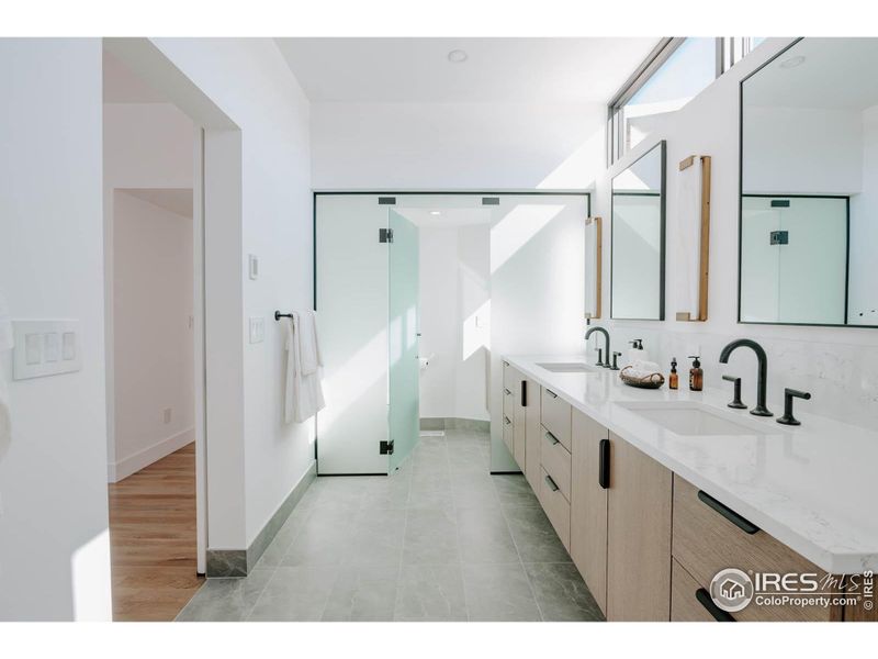 Distinctive glass partition wall separating toilet room.