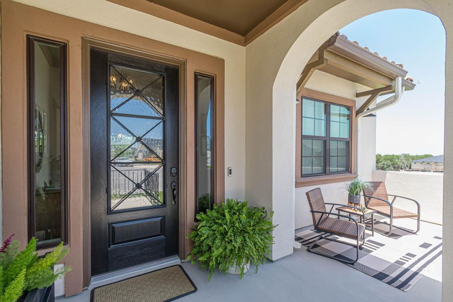 Doorway to property featuring stucco siding