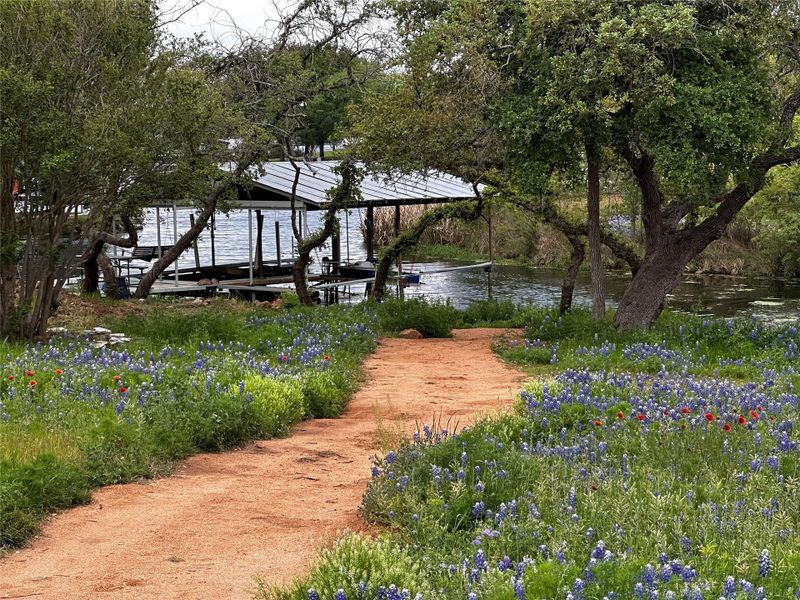 View of yard featuring a water view and a boat dock View of yard featuring a water view and a boat dock
