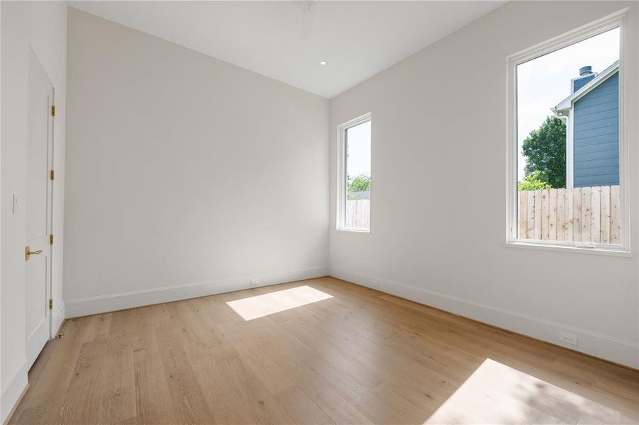 The guest bedroom features high ceilings, lots of natural light, and an ensuite bathroom.