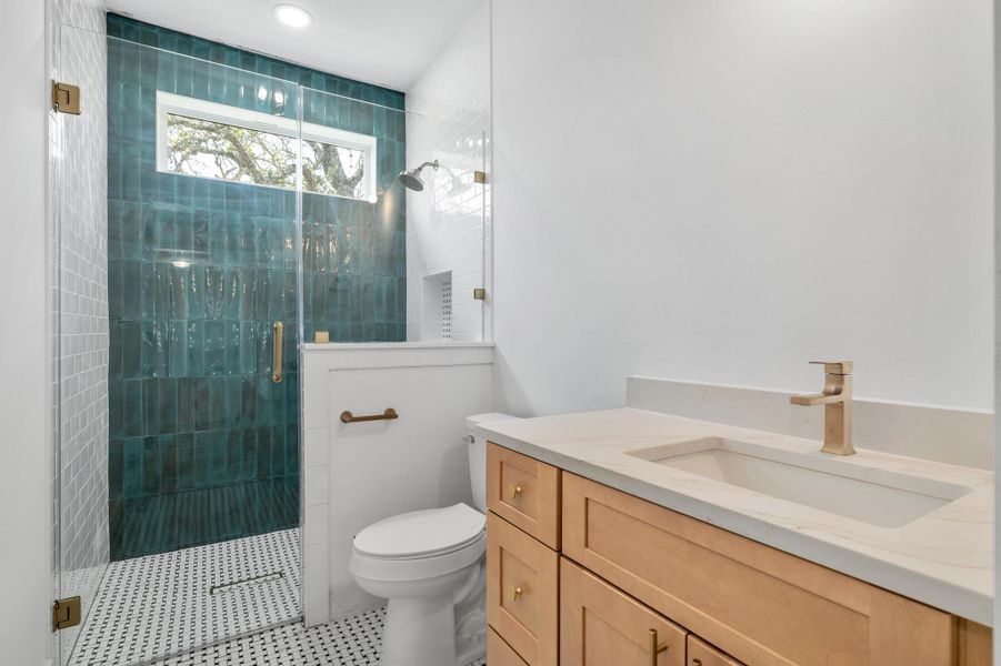 Full bath with vanity, a shower stall, and tile patterned flooring Full bath with vanity, a shower stall, and tile patterned flooring