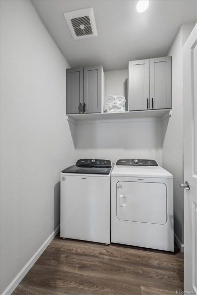 Convenient 2nd level laundry room, built-in cabinets plus full wall of shelves behind the door