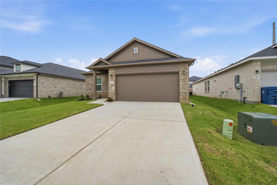 Front exterior of a new home in Steed Landing, Texas City, TX, highlighting curb appeal (Image 2). Front exterior of a new home in Steed Landing, Texas City, TX, highlighting curb appeal (Image 2).