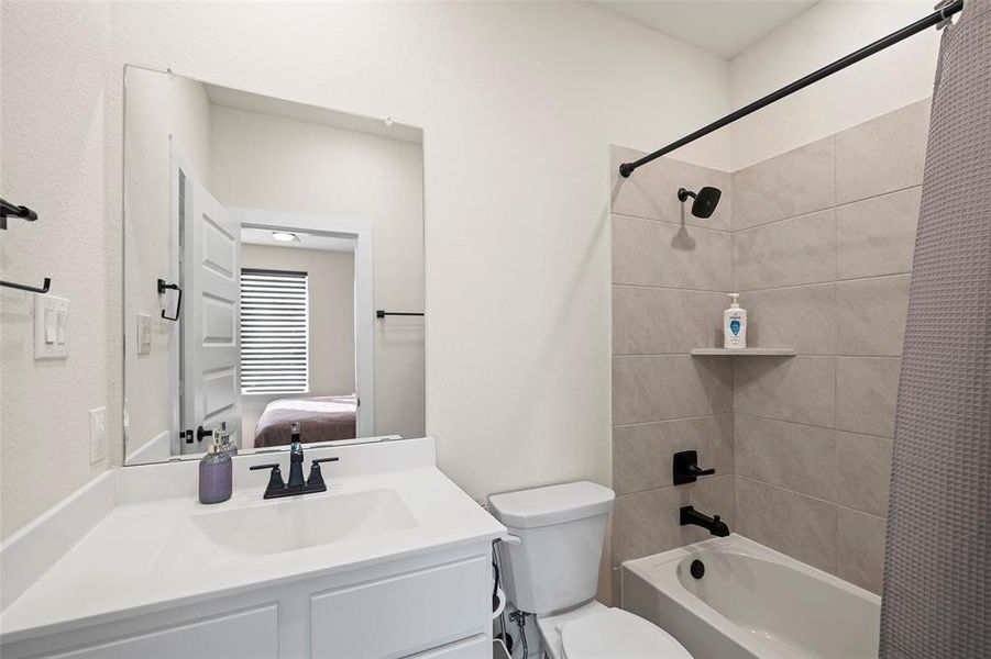 The second floor guest bathroom includes a tub/shower combination