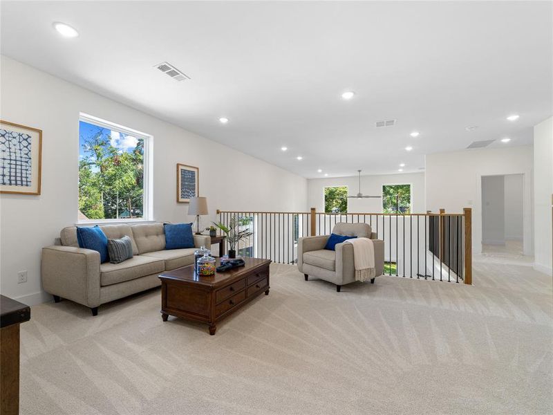 Living room with light carpet and recessed lighting