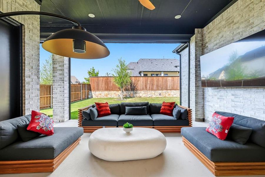 Fenced backyard with an outdoor hangout area, a patio area, and ceiling fan Fenced backyard with an outdoor hangout area, a patio area, and ceiling fan