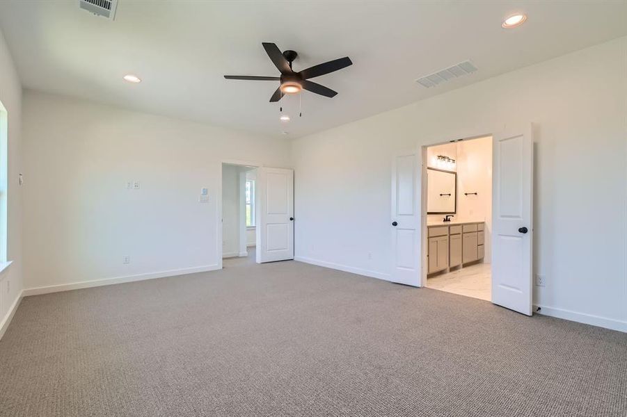 Unfurnished bedroom featuring light carpet, recessed lighting, baseboards, and connected bathroom