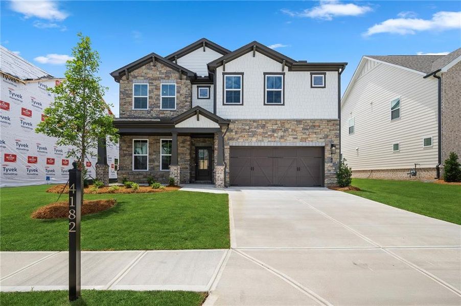 Front exterior of a new home in The Paddocks at Doc Hughes, Buford, GA, highlighting curb appeal (Image 1). Front exterior of a new home in The Paddocks at Doc Hughes, Buford, GA, highlighting curb appeal (Image 1).