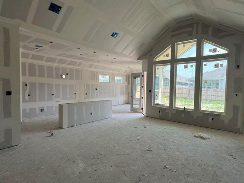 An open floorplan with vaulted ceilings and abundant natural light awaits your personal touch.