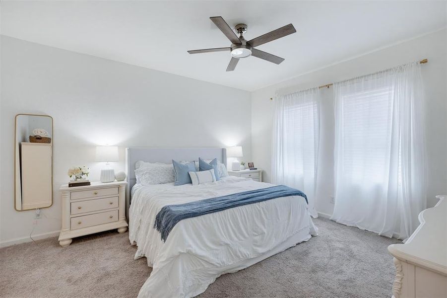 Bedroom with light gray carpeting and white walls