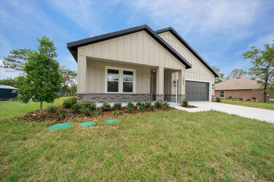 Front exterior of a new home in , Weeki Wachee, FL, highlighting curb appeal (Image 27).