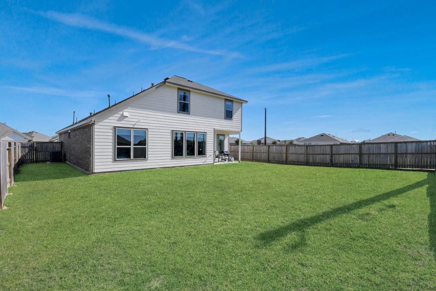 Expansive and fully fenced backyard offering privacy, room for pets, and endless outdoor possibilities.