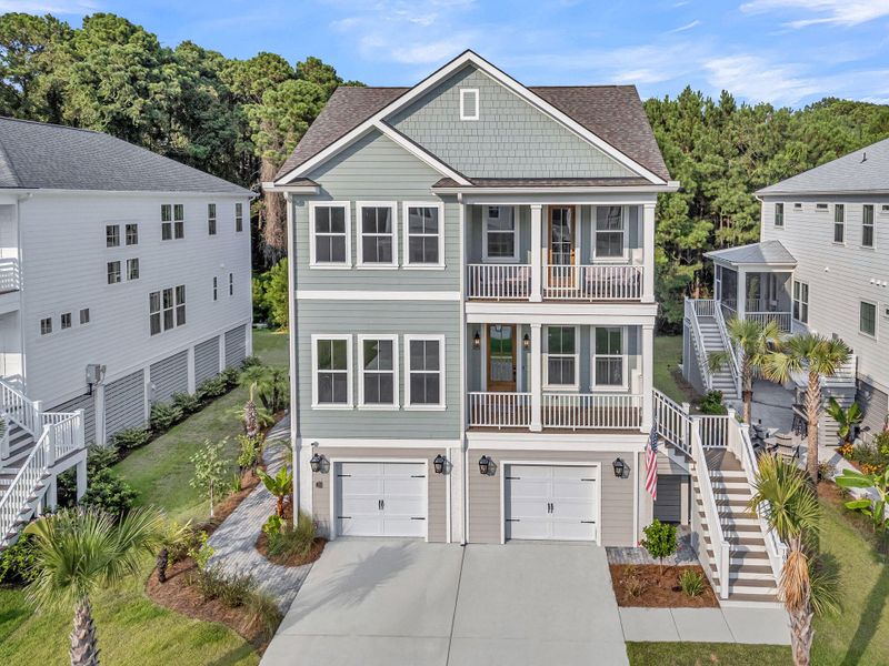 Front exterior of a new home in Overlook at Copahee Sound, Awendaw, SC, highlighting curb appeal (Image 21). Front exterior of a new home in Overlook at Copahee Sound, Awendaw, SC, highlighting curb appeal (Image 21).
