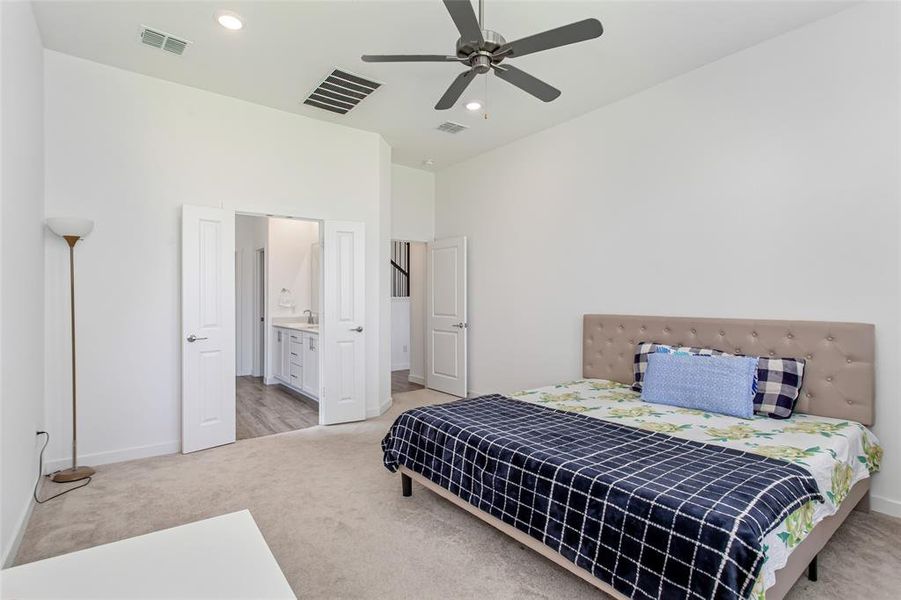 Spacious room featuring vaulted ceilings, a ceiling fan, recessed lighting, and soft carpet flooring