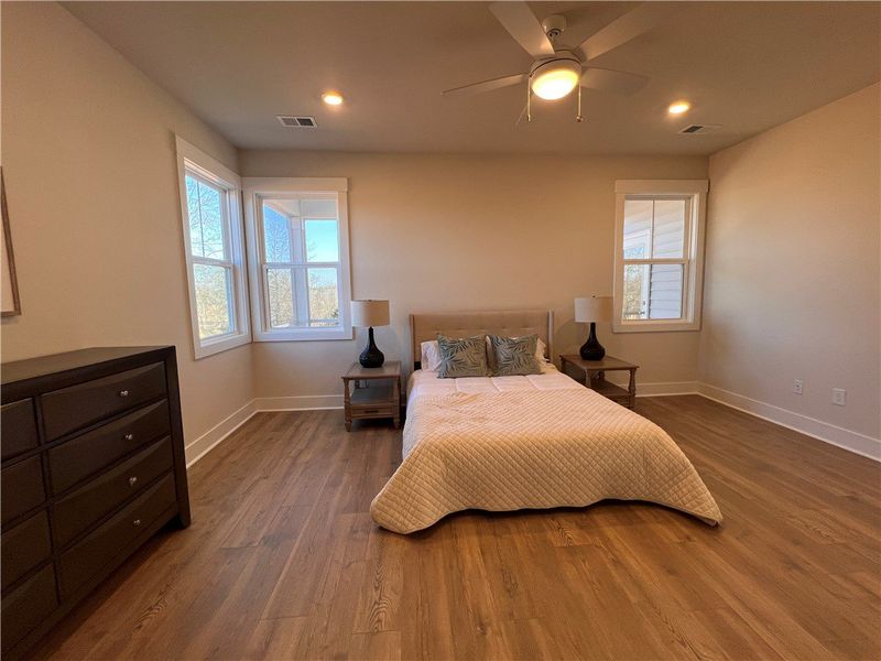 This inviting bedroom features laminate hardwood f This inviting bedroom features laminate hardwood f