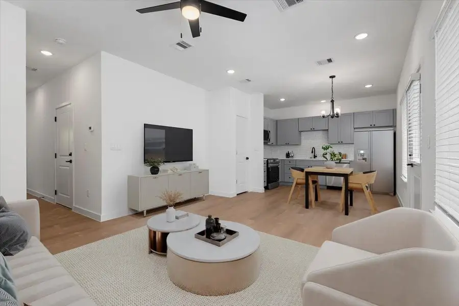 Staged --- Modern open-concept first floor featuring sleek finishes, spacious layout, and seamless flow between living, dining, and kitchen areas—ideal for everyday comfort and entertaining. Staged --- Modern open-concept first floor featuring sleek finishes, spacious layout, and seamless flow between living, dining, and kitchen areas—ideal for everyday comfort and entertaining.