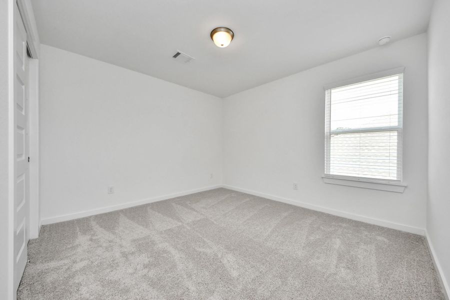 Generously sized secondary bedrooms featuring spacious closets, soft and inviting carpeting underfoot, large windows allowing plenty of natural light, and the added touch of privacy blinds for your personal retreat. Sample photo of completed home with similar floor plan. Actual colors and selections may vary. Generously sized secondary bedrooms featuring spacious closets, soft and inviting carpeting underfoot, large windows allowing plenty of natural light, and the added touch of privacy blinds for your personal retreat. Sample photo of completed home with similar floor plan. Actual colors and selections may vary.