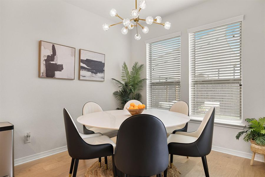 The breakfast area sits just off the kitchen and offers a comfortable space for everyday meals with a view of the backyard, updated Sputnik Chandelier