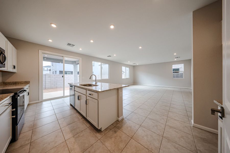 A large kitchen with a large glass door.