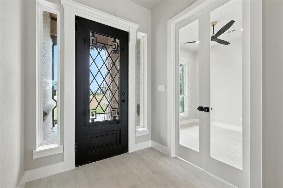 Entryway featuring ceiling fan and french doors