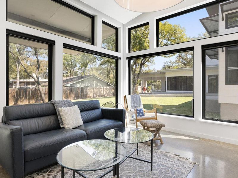 Sunroom / solarium with finished concrete floors and baseboards