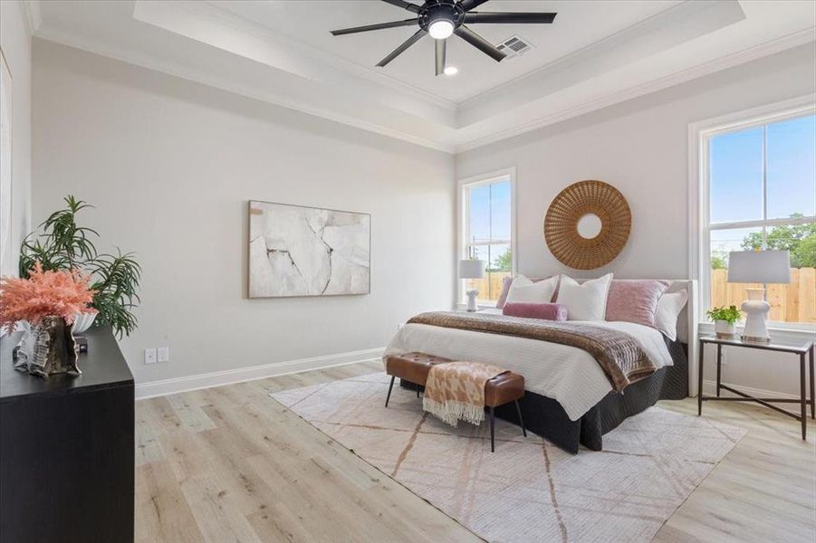 Primary bedroom featuring a trey ceiling, crown molding, vinyl flooring, recessed lighting, and a ceiling fan, etc Primary bedroom featuring a trey ceiling, crown molding, vinyl flooring, recessed lighting, and a ceiling fan, etc