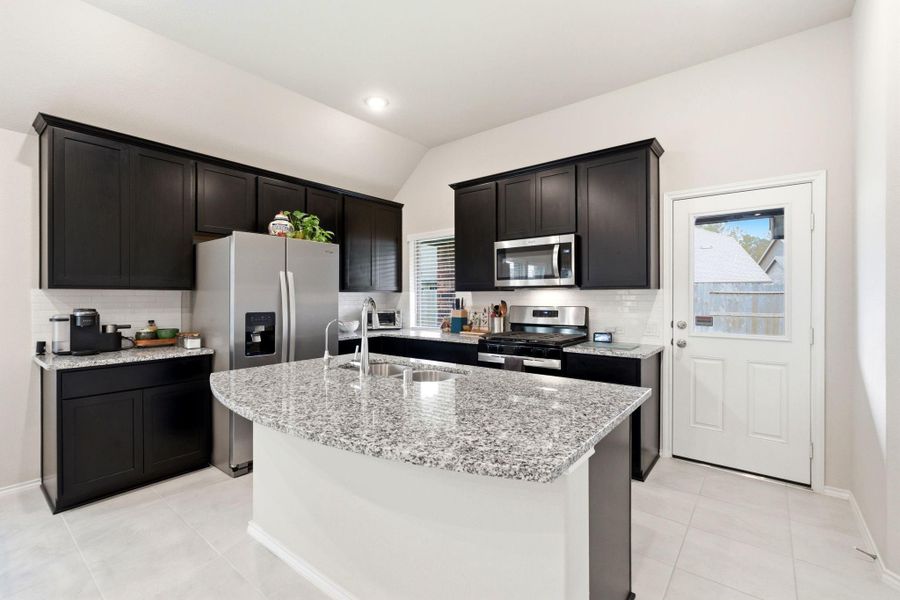 Island kitchen with an abundance of counter and cabinet space.
