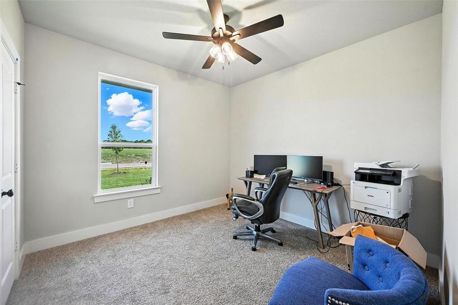 Office space with carpet floors and ceiling fan