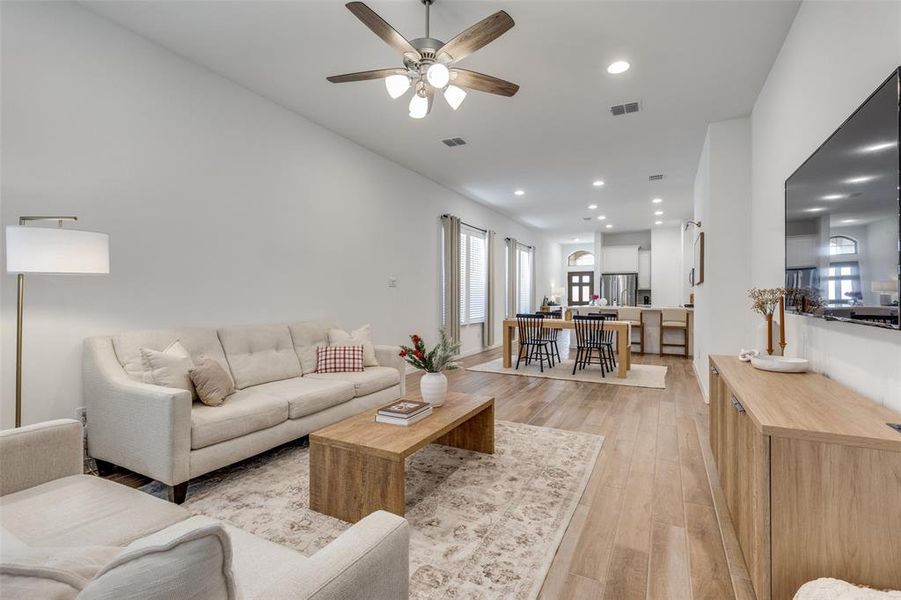 Living area with light wood-type flooring, recessed lighting, and ceiling fan