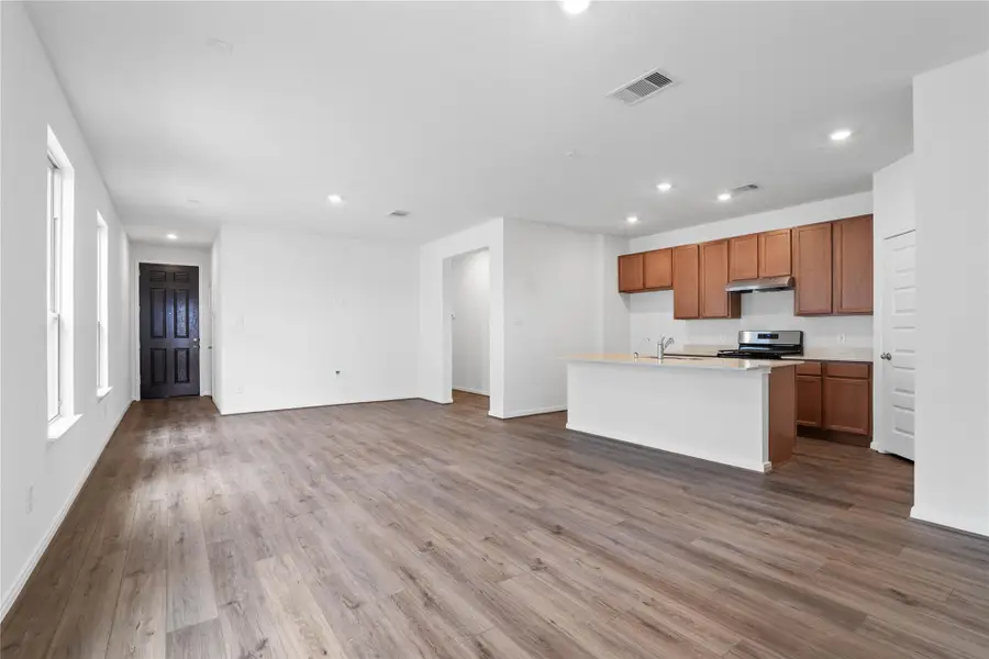 Stunning open-concept design seamlessly connecting the living, dining, and kitchen areas—perfect for both everyday living and entertaining!