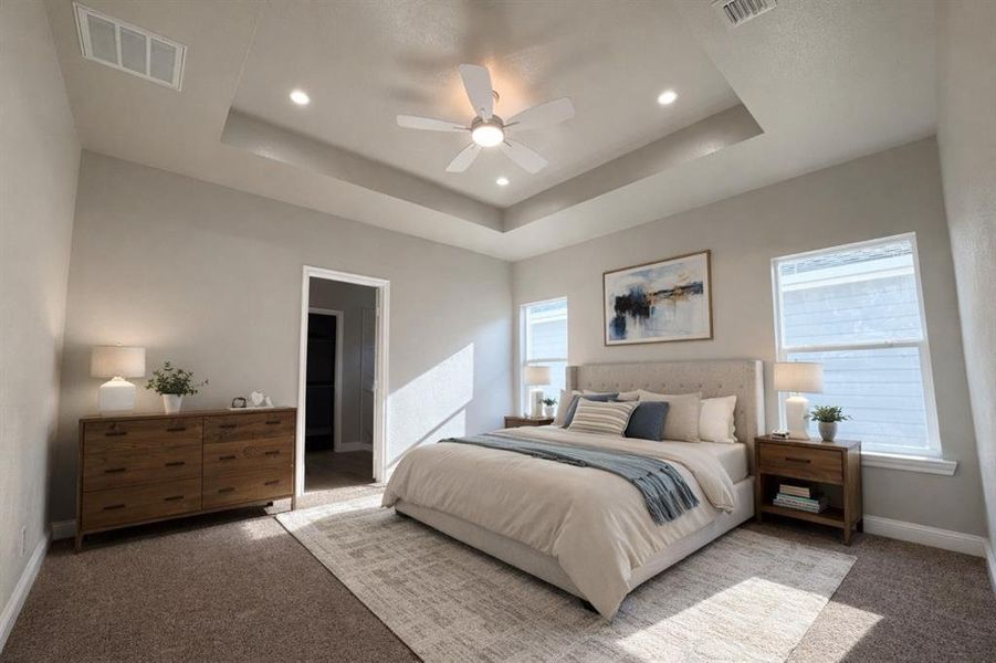 Bedroom featuring carpet flooring, a raised ceiling, a ceiling fan, and recessed lighting Bedroom featuring carpet flooring, a raised ceiling, a ceiling fan, and recessed lighting