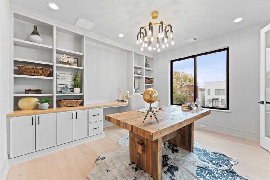 3rd floor Custom built-ins study with warm wood accents opens to game room.