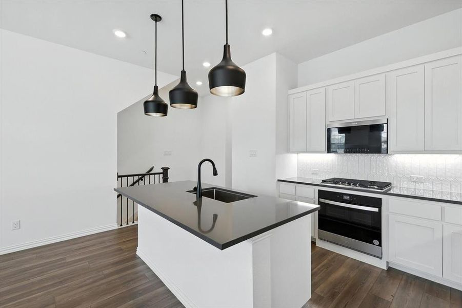 Stunning white shaker type cabinetry. Stainless steel appliances and a microwave that combines as an air fryer.