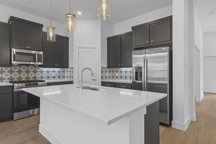 Representative furnished interior of a home built from the Athens by Chesmar Homes in Sunterra, Katy (Image 6).