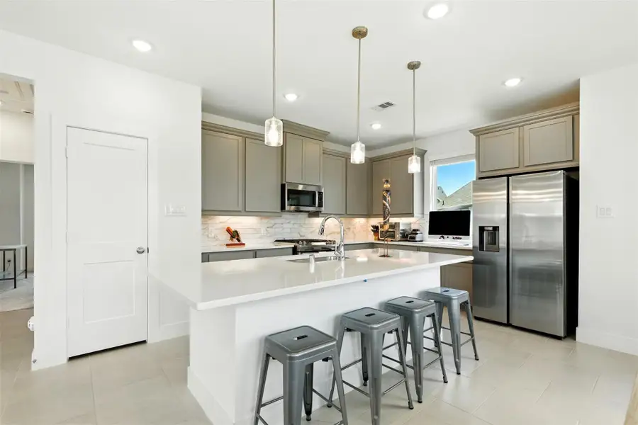 The kitchen, an integral part of thishome's open-concept design,seamlessly flows off the living room,creating a harmonious andconnected living space. The kitchen, an integral part of thishome's open-concept design,seamlessly flows off the living room,creating a harmonious andconnected living space.