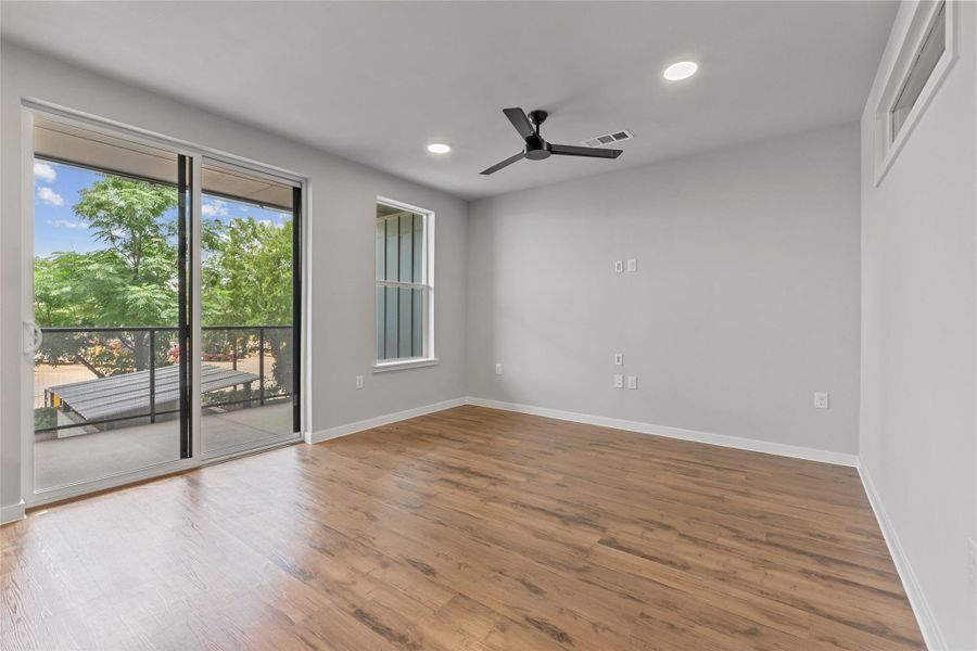 Spare room with a ceiling fan, recessed lighting, and wood finished floors