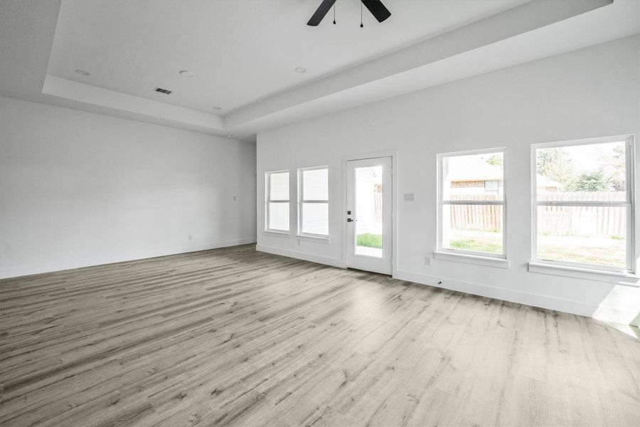 The room features a door leading to the backyard, offering plenty of natural light and outdoor access.