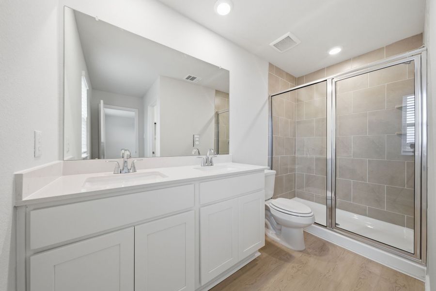 A bathroom with a glass shower. A bathroom with a glass shower.