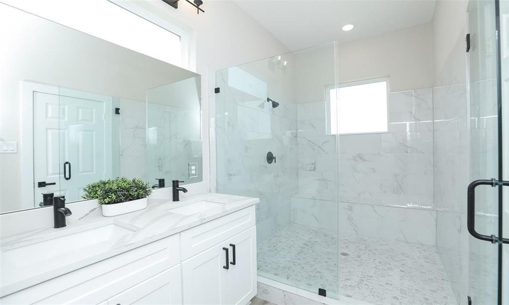 Huge walk in shower with marble tile in this peaceful primary suite!