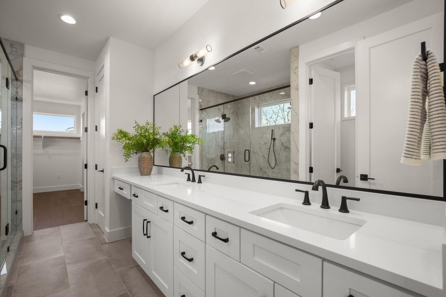 Lux ensuite primary bathroom with dual vanities and dedicated make up station