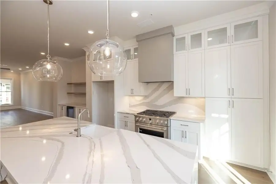 One of the best features of this plan is the stunning kitchen layout- come visit and feel the difference of the elevated finishes in Byers Park.