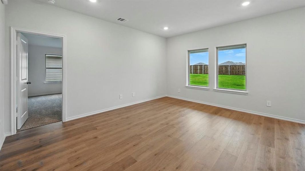 Spare room with dark wood-style flooring and recessed lighting