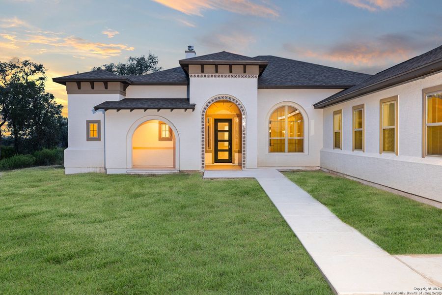 Front exterior of a new home in Potranco Acres, Castroville, TX, highlighting curb appeal (Image 1). Front exterior of a new home in Potranco Acres, Castroville, TX, highlighting curb appeal (Image 1).