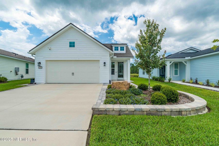 Front exterior of a new home in Summer Bay at Grand Oaks, St. Augustine, FL, highlighting curb appeal (Image 20). Front exterior of a new home in Summer Bay at Grand Oaks, St. Augustine, FL, highlighting curb appeal (Image 20).