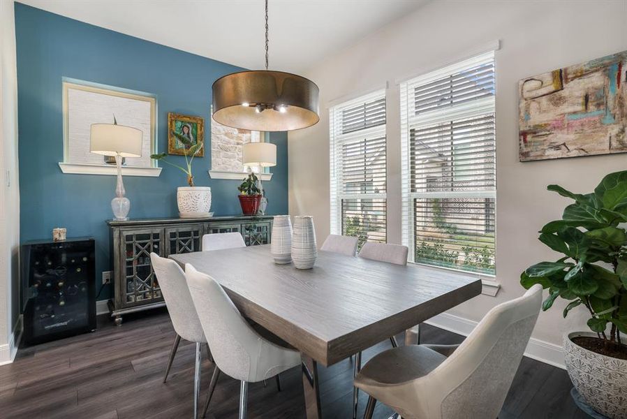 Dining room featuring wine cooler and dark wood-style flooring
