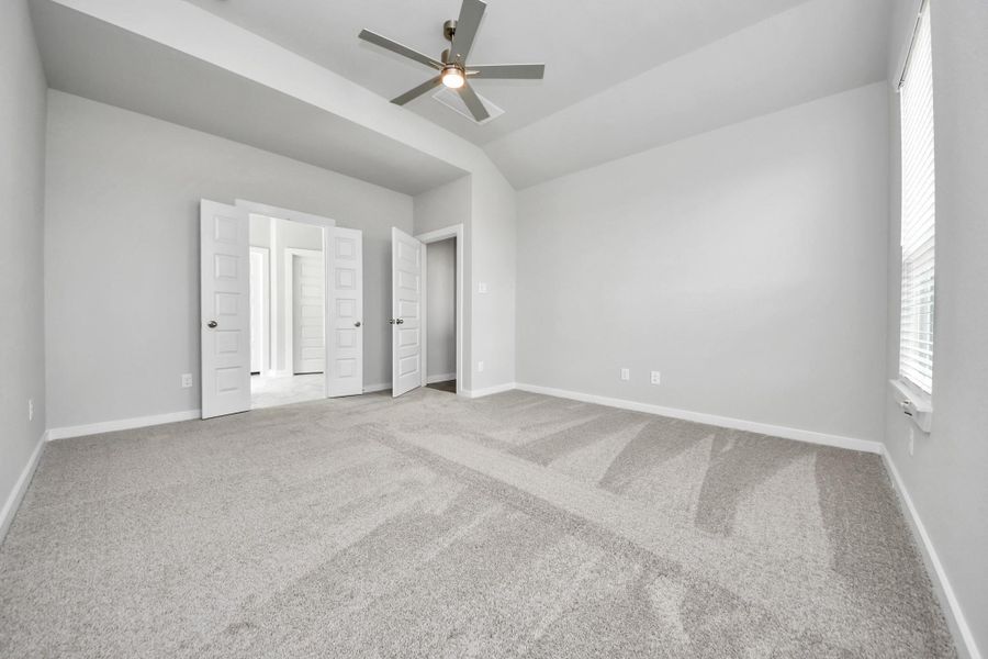 Come and unwind after a long day in this magnificent primary suite! This spacious room features plush carpet, warm paint, high ceilings and large windows with privacy blinds.