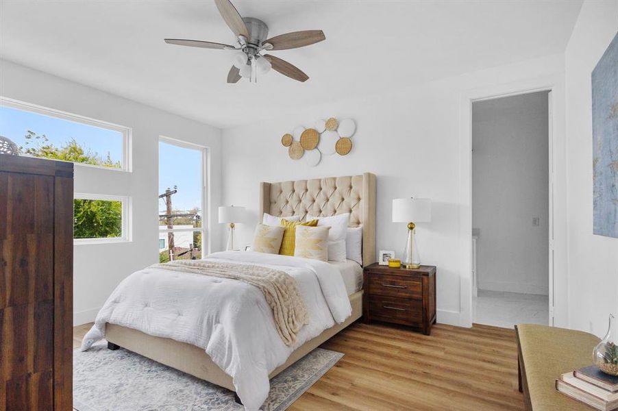 Bedroom featuring ceiling fan and light hardwood / wood-style flooring